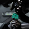 Man Hanging Coconut Air Freshener in Car