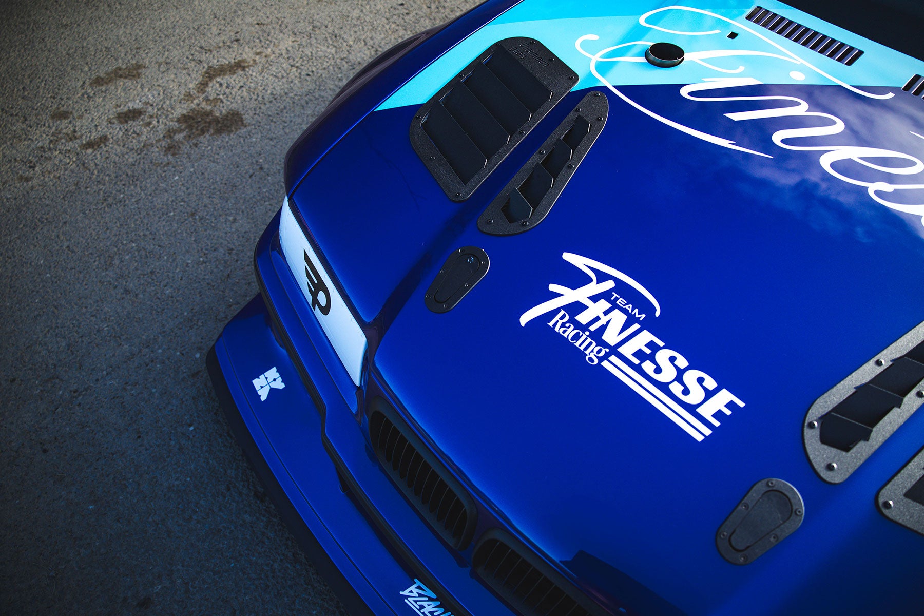 Blue car with Auto Finesse Logo