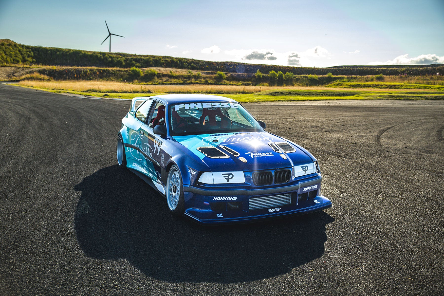 Blue car with Auto Finesse Logo