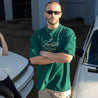 Man Wearing Detailers T-Shirt - Green